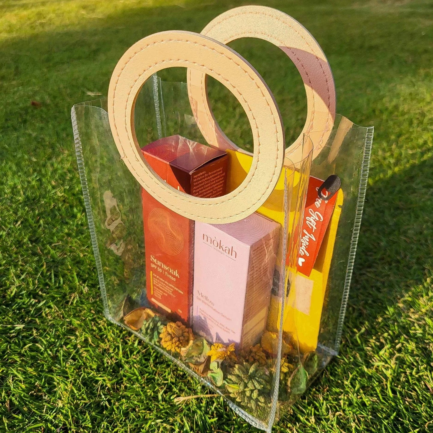 Mòkah Bestseller Duo with skincare products in a clear pouch on grass.