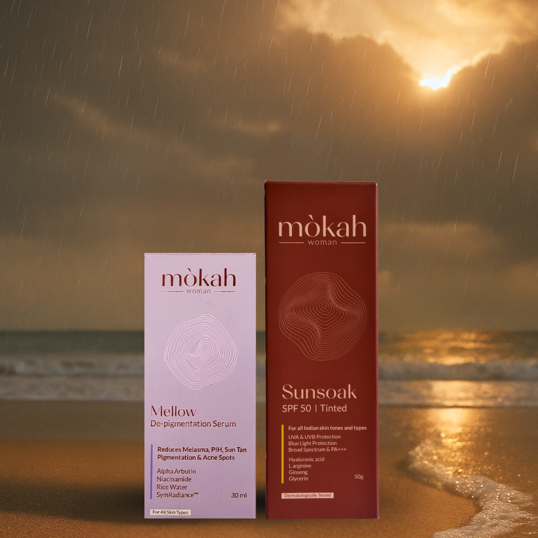Mòkah Mellow De-pigmentation Serum and Sunsoak SPF 50 Tinted Sunscreen on a beach backdrop with a sunset.