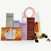 Mòkah Golden Glow Set with toner, de-pigmentation serum, moisturizing serum, tinted SPF 50 sunscreen, hot chocolate, and GlowUp bag for hydrated, even-toned skin.