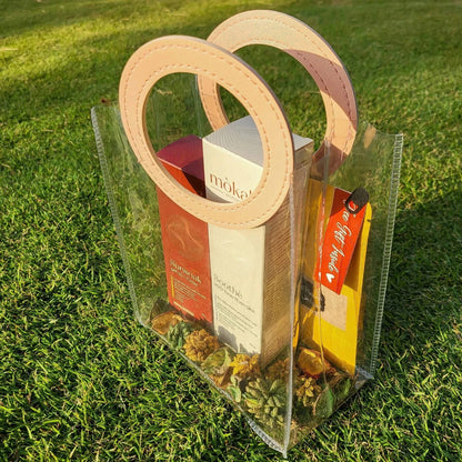 Mòkah Pollution Protect Duo in a stylish clear bag on grass, featuring skin barrier protection products for hydration and sun defense.